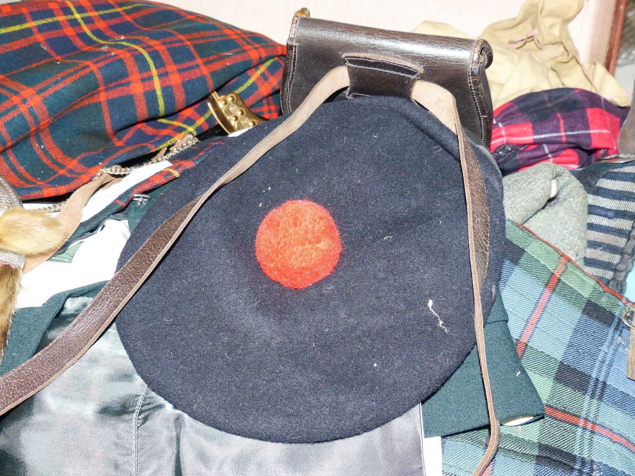 A group of early 20th century men’s and women’s tartan clothing, a electroplate mounted sporran etc.